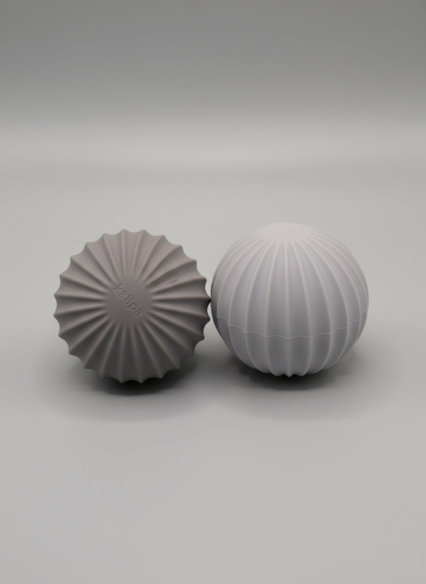 Pair of 3kg weighted exercise balls in Andes Taupe and Oat Latte colors for home and studio practice