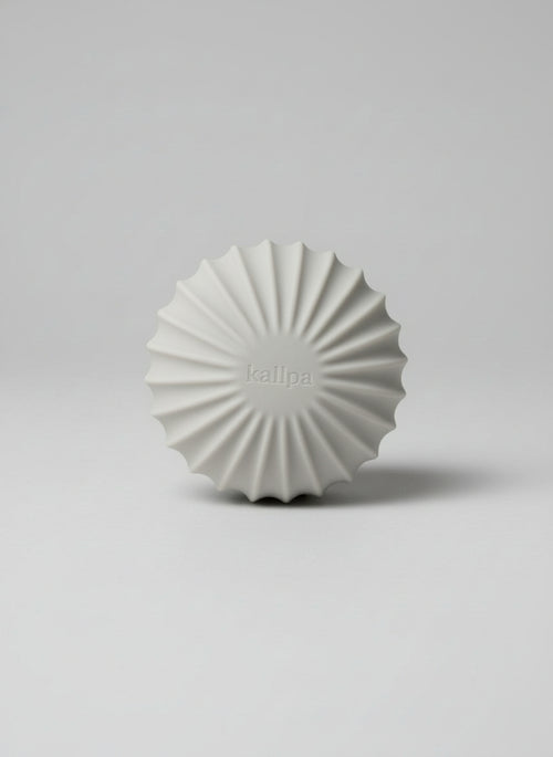 Minimalist 1.5kg weighted Pilates ball (front side) in oat latte silicone for toning and deep muscle engagement